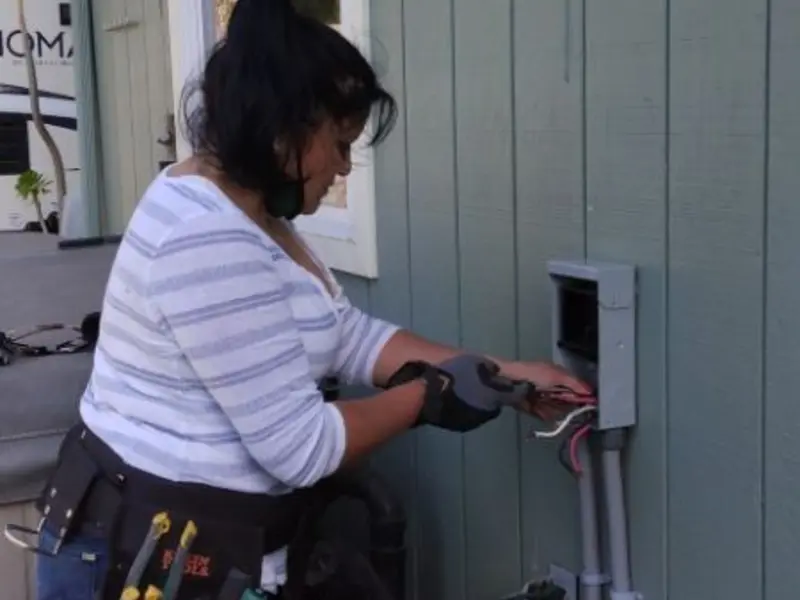 Licensed electrician wiring an exterior subpanel in Air Force Academy