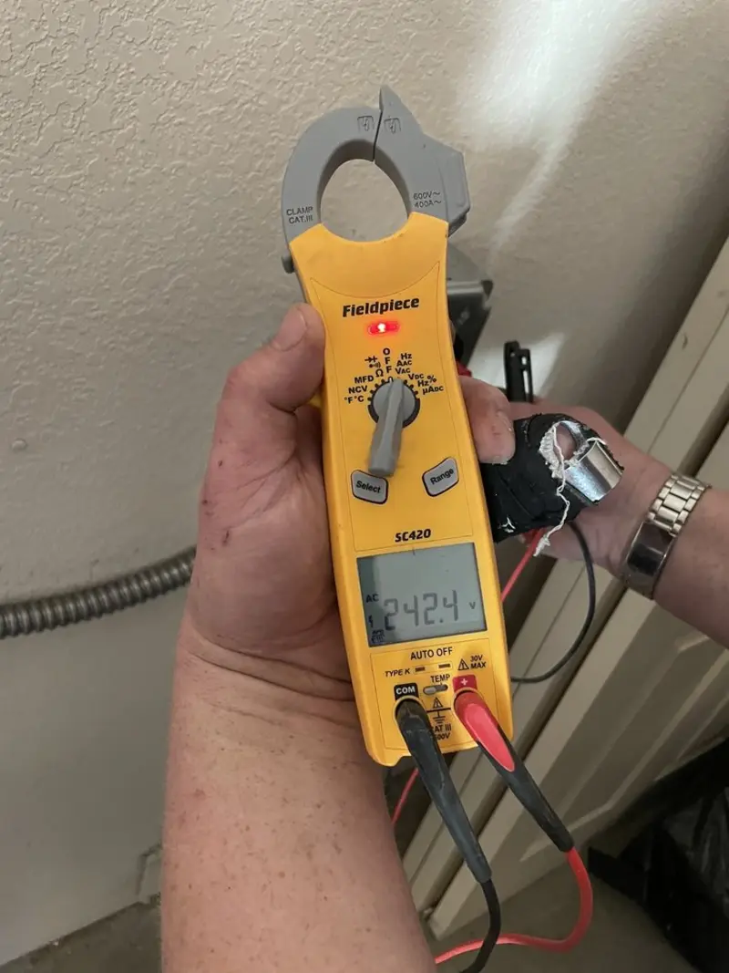 Voltage testing with clamp meter during Electrical Installation Services in Air Force Academy